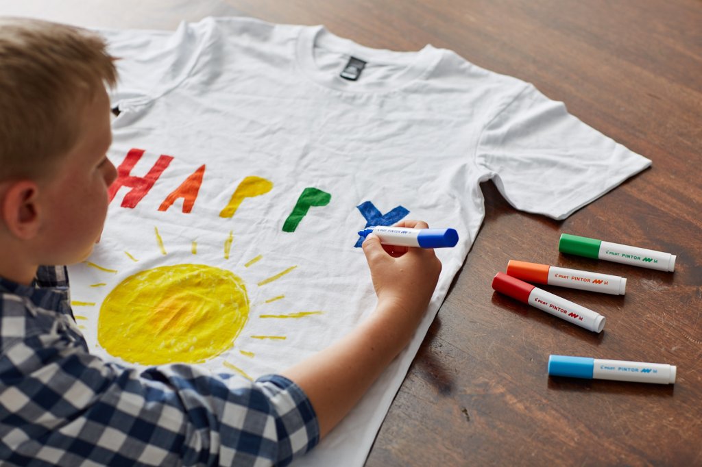 Child drawing on T-shirt with PILOT Pen Pintor craft markers.