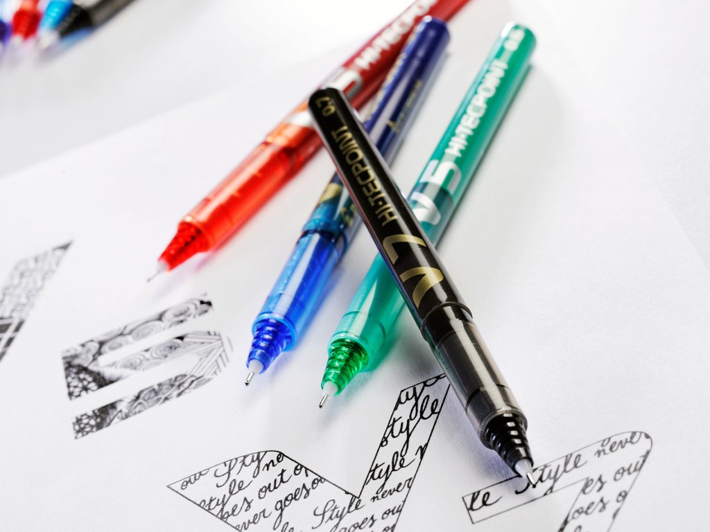 Pilot Hi-tecpoint rollerball pen in four colours, laying on top of detailed sketches.